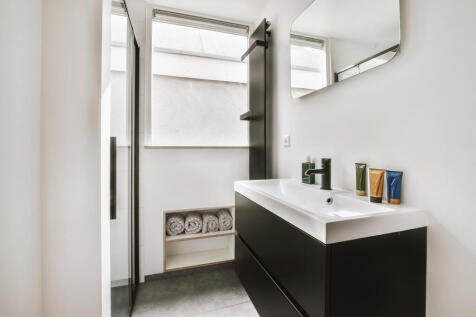 sink-and-mirror-near-bathroom-door-2025-02-09-23-1