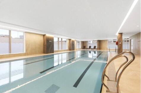 Contemporary apartment in the sought-after River Gardens development, offering resort-style amenities including gym, swimming pool, and tennis court. Bright open-plan living with hardwood floors and f