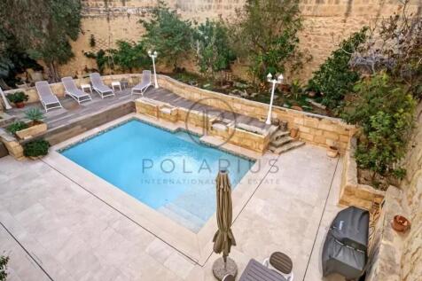 A cozy backyard features a small rectangular pool