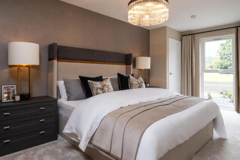 Image of bedroom with chest side table, and floor to ceiling window in a 2 bedroom apartment at Ston