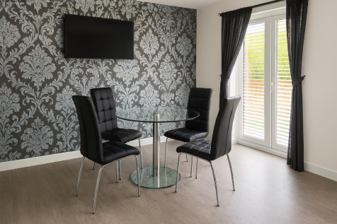 Modern fitted kitchen open to dining room