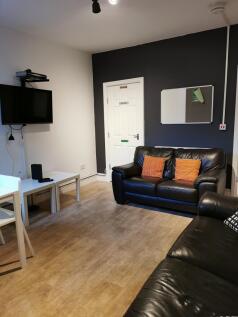 Contemporary communal lounge with two black lea...