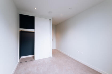 Experience comfort in this airy bedroom with a sleek built-in closet, perfect for modern living.