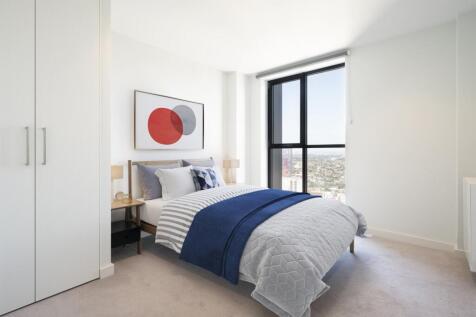 Relax in a beautifully designed bedroom featuring breathtaking city views.