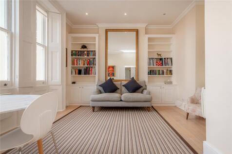 An elegant stucco-fronted period building on one of South Kensington's most sought after garden squares.