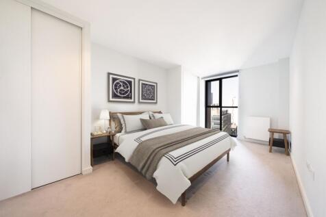 Relax in this beautifully designed bedroom, featuring ample natural light and sophisticated furnishings.