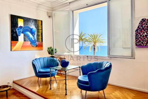 Bright living room with ocean views, featuring vib
