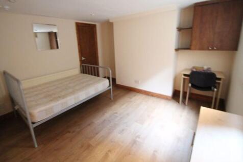 A well-maintained single bedroom with wooden fl...