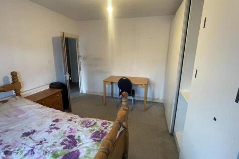 Bright, simply furnished bedroom with a comfort...