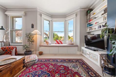 Located on a quiet residential street near vibrant Brixton and leafy Brockwell Park, this bright and characterful split-level home offers a generous reception room, two bedrooms, a study, and a separa
