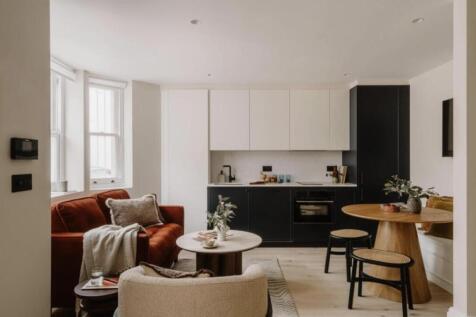 A beautifully refurbished lower ground floor apartment in the heart of Notting Hill, finished to an exceptional standard throughout. The generous open-plan living space features a striking two-tone ki