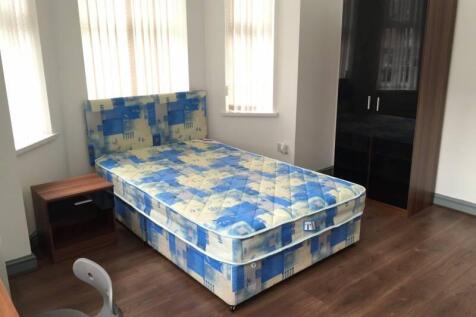 Bright furnished bedroom with a patterned doubl...