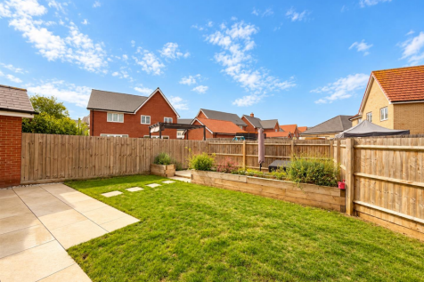 Sunny Suburban Garden with Raised Planters.png