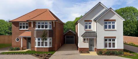 Two modern detached houses with front gardens and a driveway, one with red brick and the other with