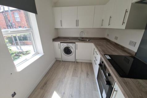 A bright and modern kitchen with ample workspac...