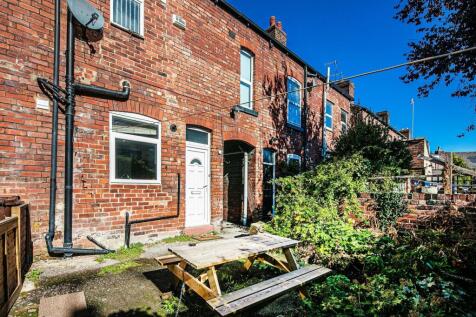 Sunny rear yard of a traditional red-brick terr...