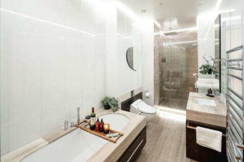 Bright, contemporary bathroom featuring a built...