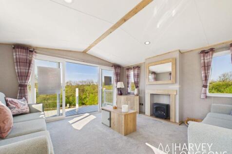 Bright living room with sofas and patio doors in A