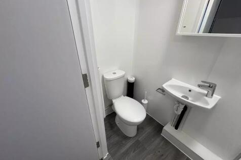 Compact modern bathroom with white sanitaryware...
