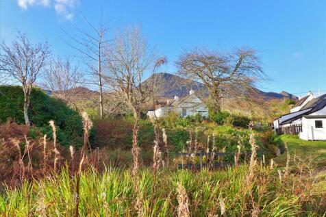 View towards cottage from track