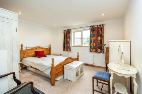 A spacious double bedroom with garden views and a