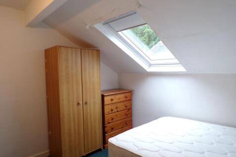 Bright attic bedroom with a large skylight, fit...