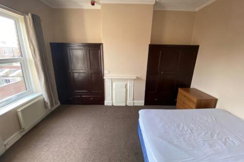 A spacious and bright double bedroom featuring ...