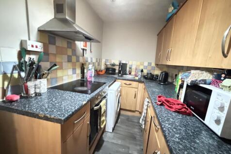 A well-equipped kitchen featuring wooden cabine...
