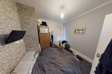 A cozy bedroom with a large bed, featuring a wi...