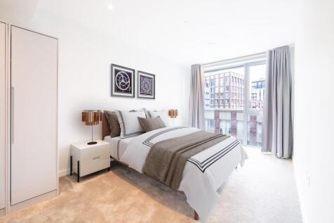 Experience urban elegance in this stylish bedroom with a stunning city view.