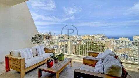 Spacious balcony with stylish outdoor seating and