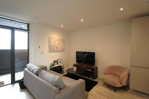 Fully furnished one-bedroom apartment at 55 Queen Street, Salford, featuring open-plan living, modern kitchen, double bedroom and stylish bathroom. Residents benefit from on-site gym and co-working sp