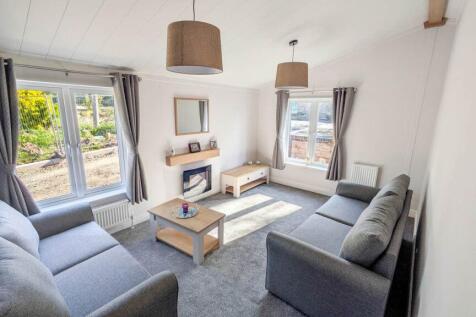 Contemporary Lounge With Grey Sofas And Windows