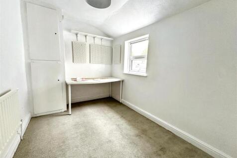 Bright study space with built-in desk and stora...