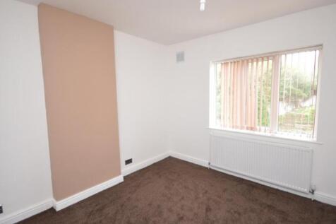 A bright and tidy bedroom with neutral walls an...