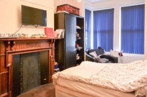 A comfortably furnished living room featuring a...