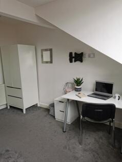 Bright, neatly presented bedroom corner with a ...