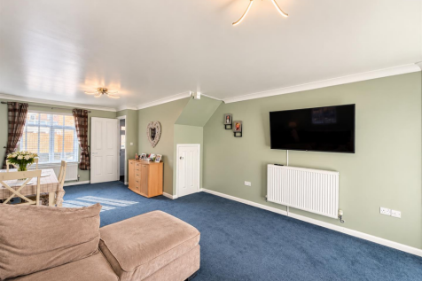 Sage Green Living Room with Blue Carpet.png