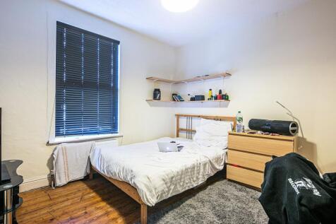 Bright double bedroom with wooden floors, a sim...