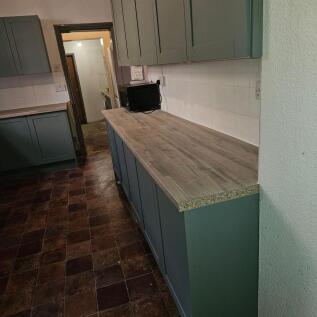 A kitchen featuring modern blue cabinetry and a...