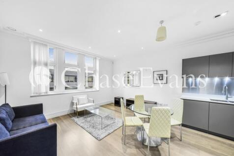 A one bedroom apartment in a restored Edwardian building part of Goodman's Fields. The spacious open plan kitchen/lounge has integrated kitchen units and features timber floorboards throughout extendi