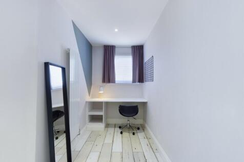 A small, clean bathroom featuring a modern toil...