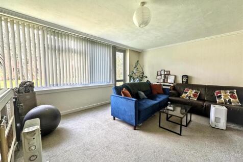 Bright lounge with large window and modern seat...