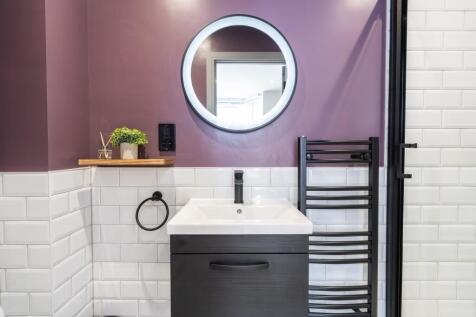 Modern bathroom featuring a sleek white sink wi...