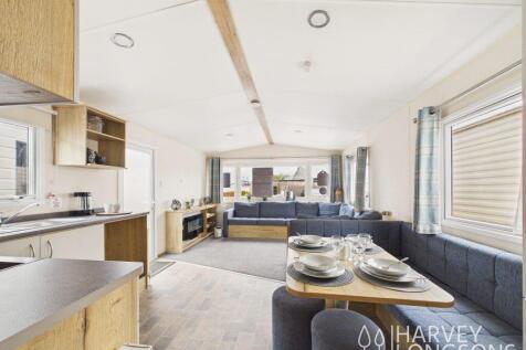 Open plan holiday home interior with lounge dining