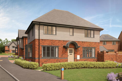 A modern brick and siding house with a manicured lawn and a paved driveway sits under a clear blue s