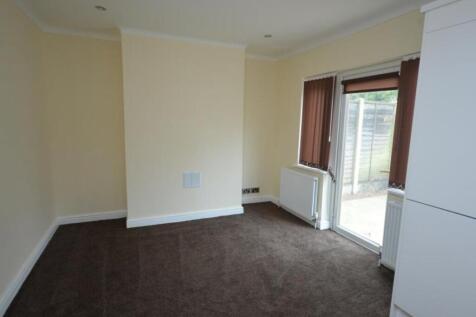 A bright and tidy living room featuring neutral...