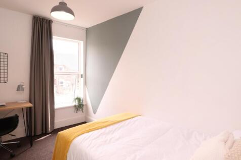A bright and inviting double bedroom featuring ...