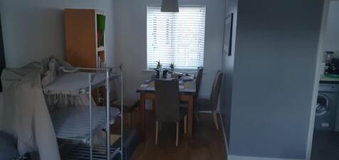 Bright eat-in space with a window-dressed dinin...