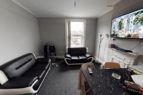 A modern, well-lit living room with comfortable...